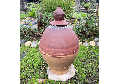 Large lidded pot decorating a garden