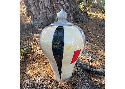 Large lidded pot decorating a garden